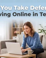 Woman taking an online defensive driving course on a laptop at home – hero image for a blog about completing defensive driving online in Texas.